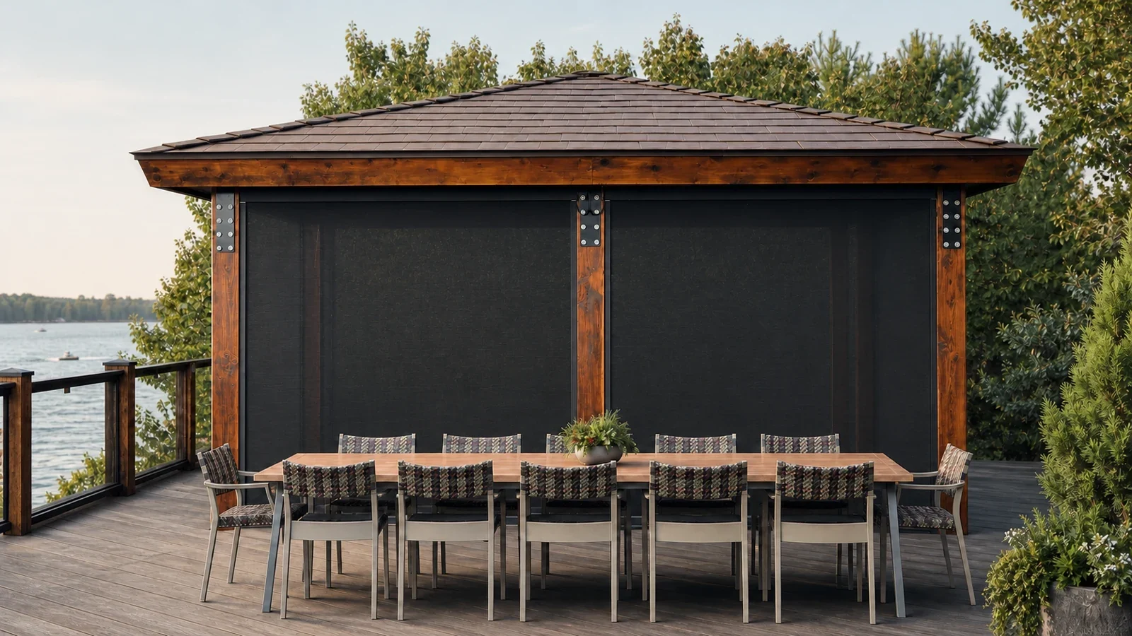 Exterior view of a lakeside gazebo enclosed by motorized mesh screens